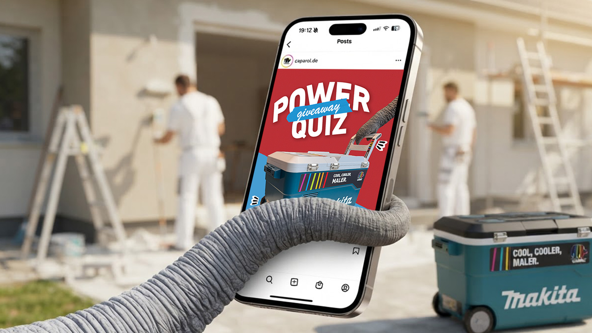 Smartphone showing the Caparol Power Quiz beside a tool case