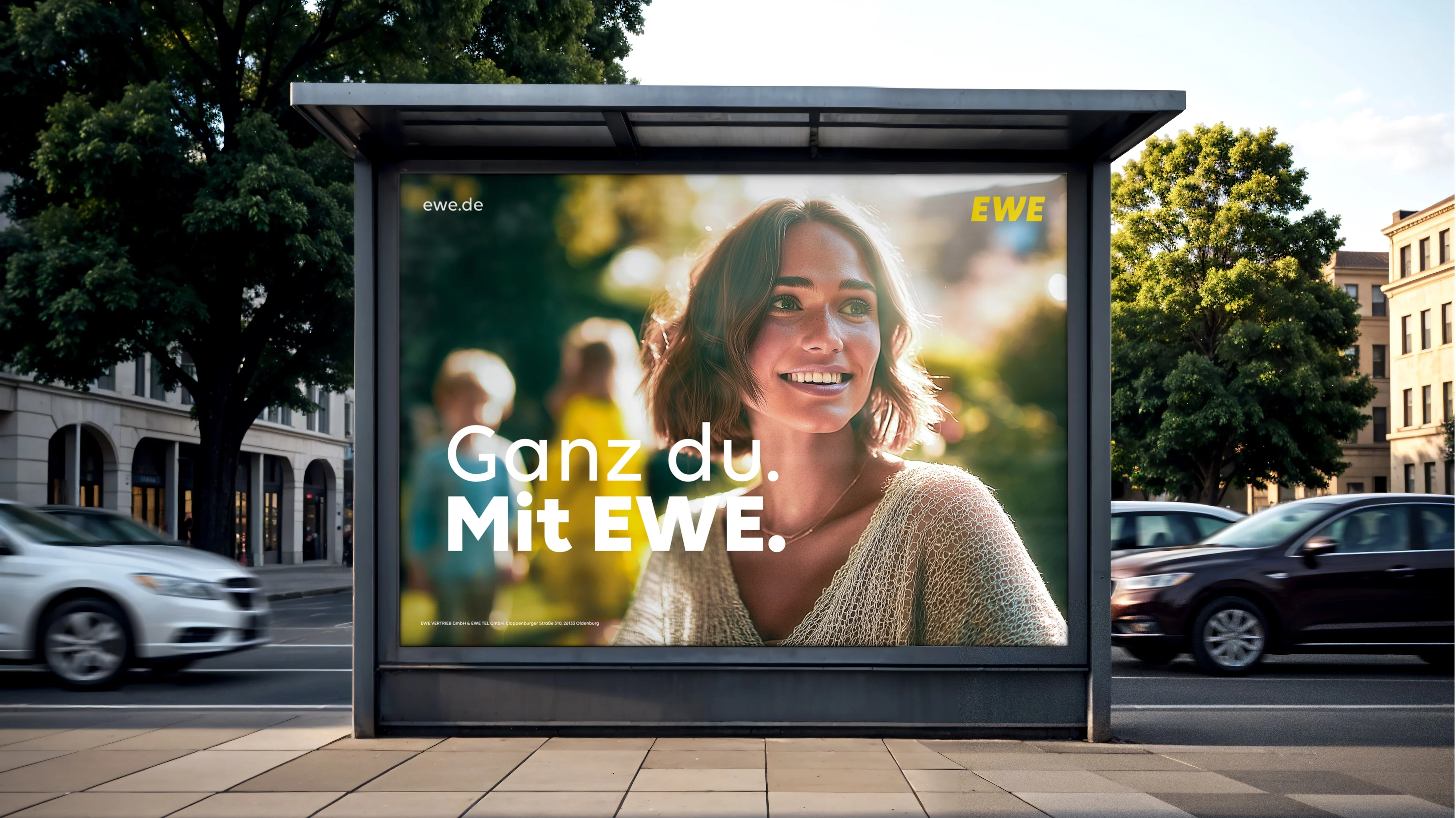 Ganz Du. Mit EWE. on an outdoor advertising display with a portrait.